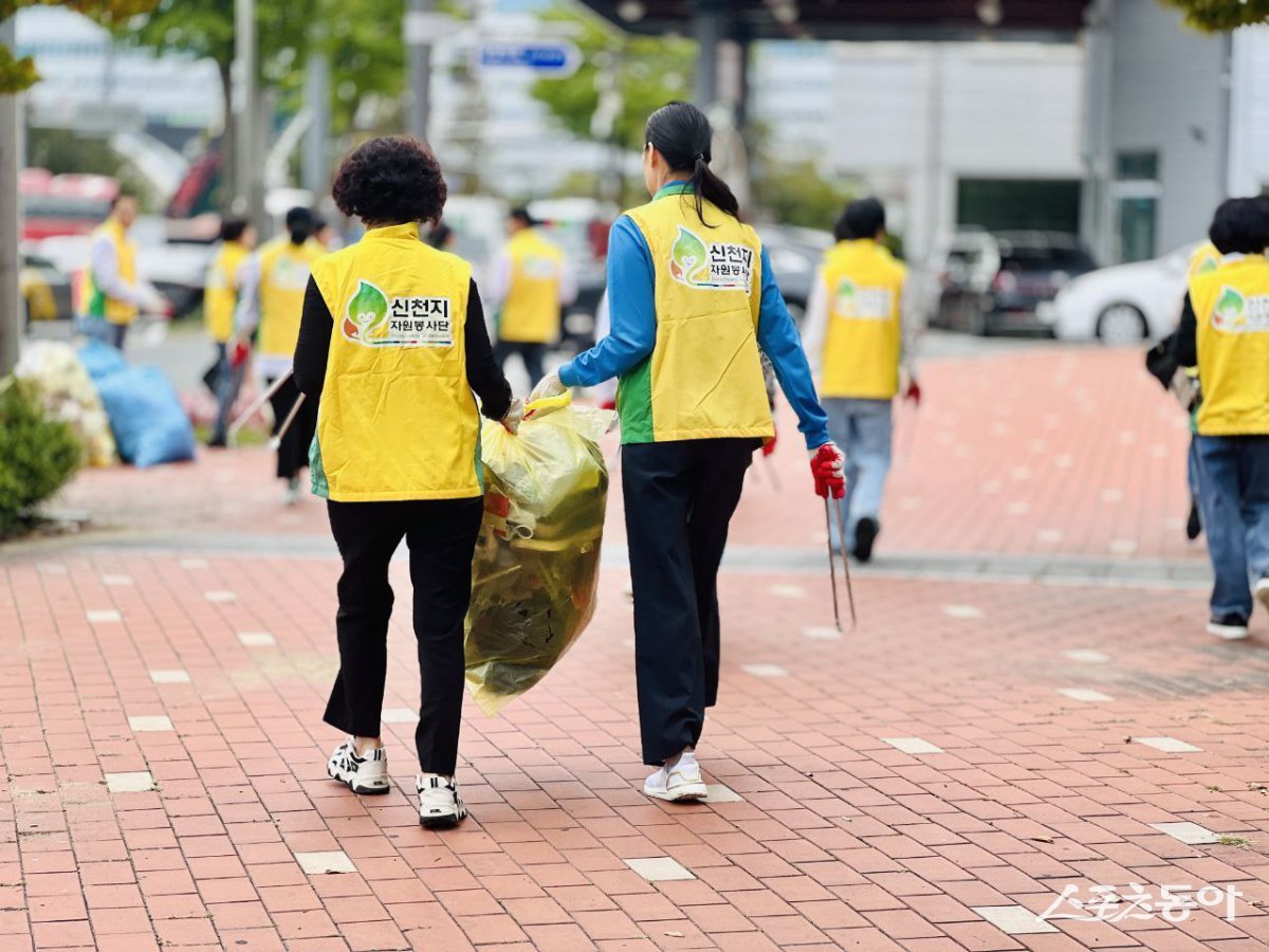 신천지자원봉사단 마산지부가 지난 21일 창원역 인근에서 ‘우리 마을 줍깅 데이’ 활동을 진행한 가운데 봉사자들이 쓰레기를 담은 봉투를 옮기고 있다. (사진제공=신천지자원봉사단 마산지부)