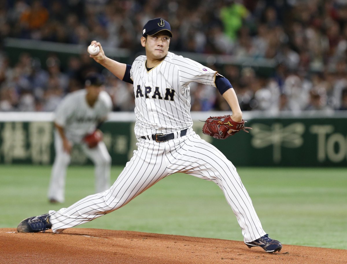 FILE - In this March 14, 2017, file photo, Japan starting pitcher Tomoyuki Sugano throws to a Cuba batter during the first inning of a second-round game at the World Baseball Classic in Tokyo. Japanese star pitcher Tomoyuki Sugano has been posted by the Yomiuri Giants and is available for bidding to major league teams. The bidding starts at 8 a.m. EST Tuesday, Dec. 8, 2020 and runs through 5 p.m. EST on Jan. 7. (AP Photo/Toru Takahashi, File)