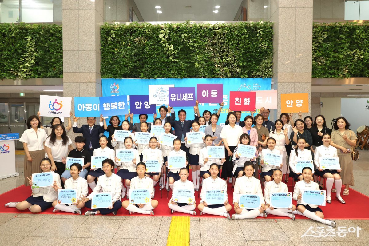 지난 20일 시청 로비에서 열린 아동친화도시 인증 선포식에서 최대호 안양시장과 아이들이 ‘아동친화도시 안양’에 바라는 점을 적은 팻말을 들고 기념촬영을 하고있다. 사진제공｜안산시