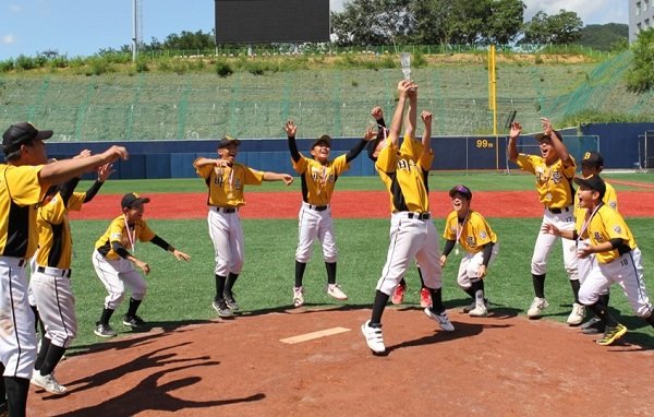 U-12 부문에서 우승을 차지한 용인바른리틀 야구단 선수들이 트로피를 들고 환호하고 있다.