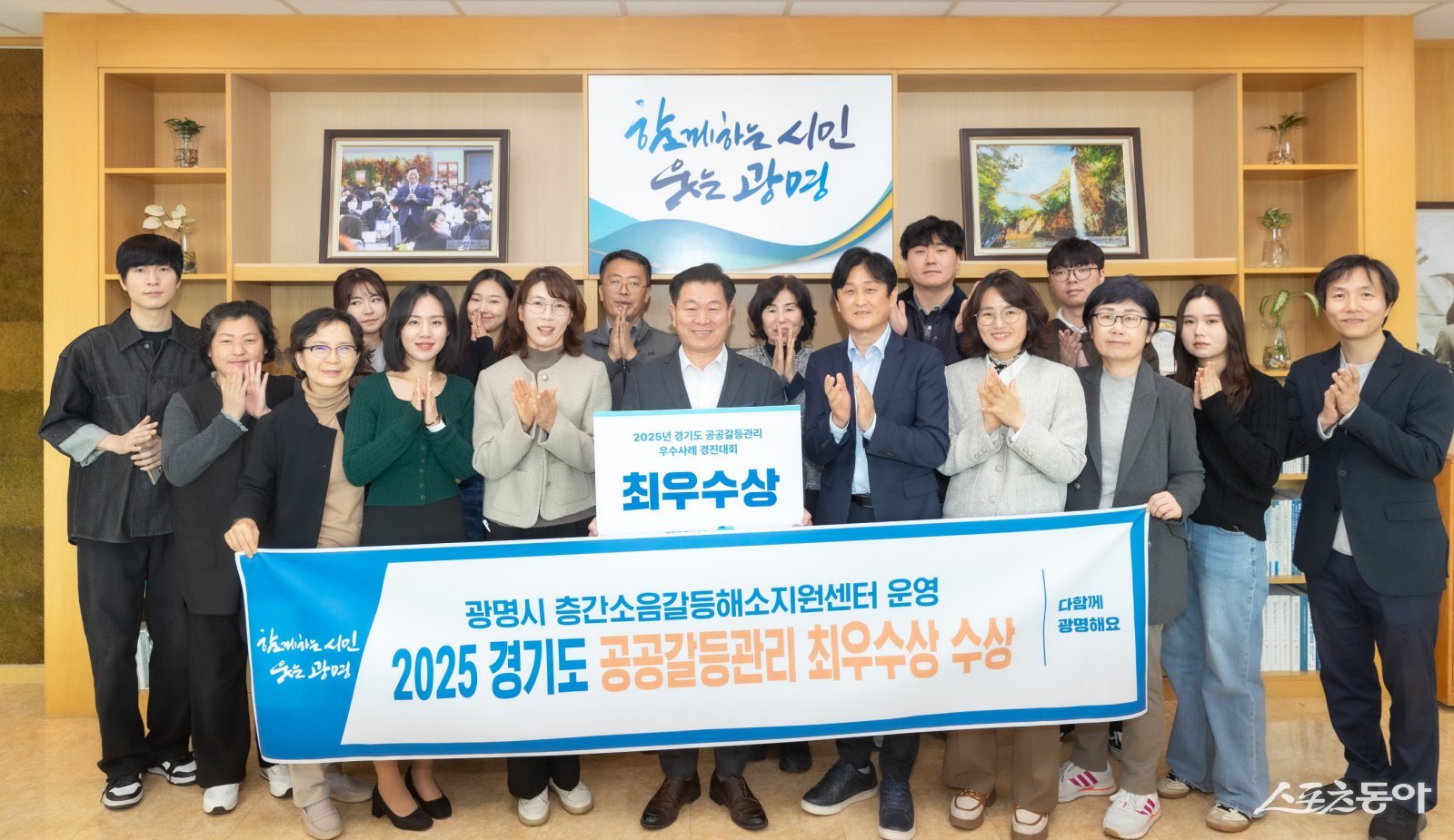 박승원 광명시장이 시민소통관과 주택과 직원들과 함께 경기도 2025년 공공갈등관리 우수사례 경진대회 최우수상 수상 기념사진을 촬영하고 있다.사진제공|광명시