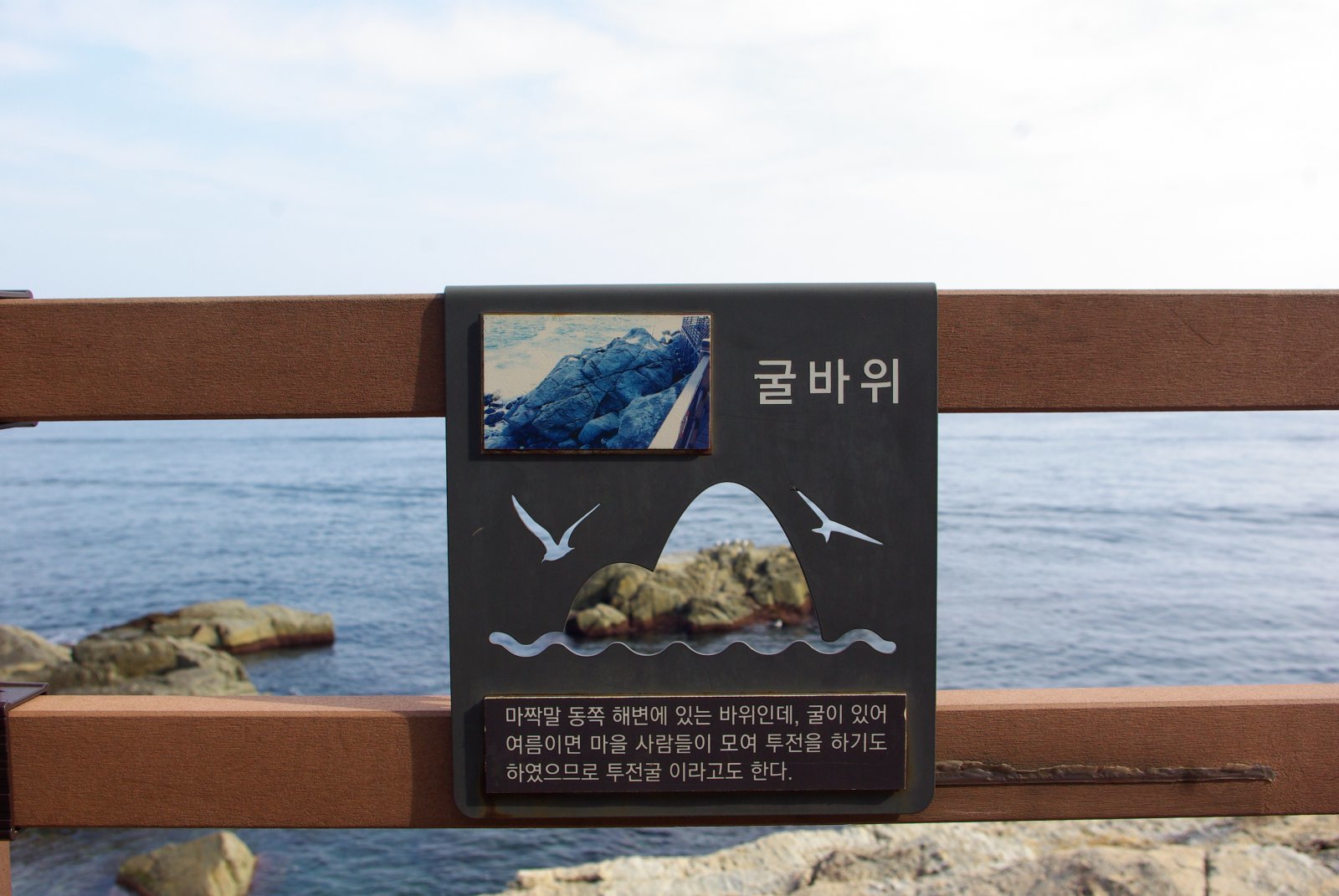 데크 곳곳 안내판을 읽는 재미도 쏠쏠하다. 굴바위 안내판 구멍 사이로 ‘굴바위’가 보인다