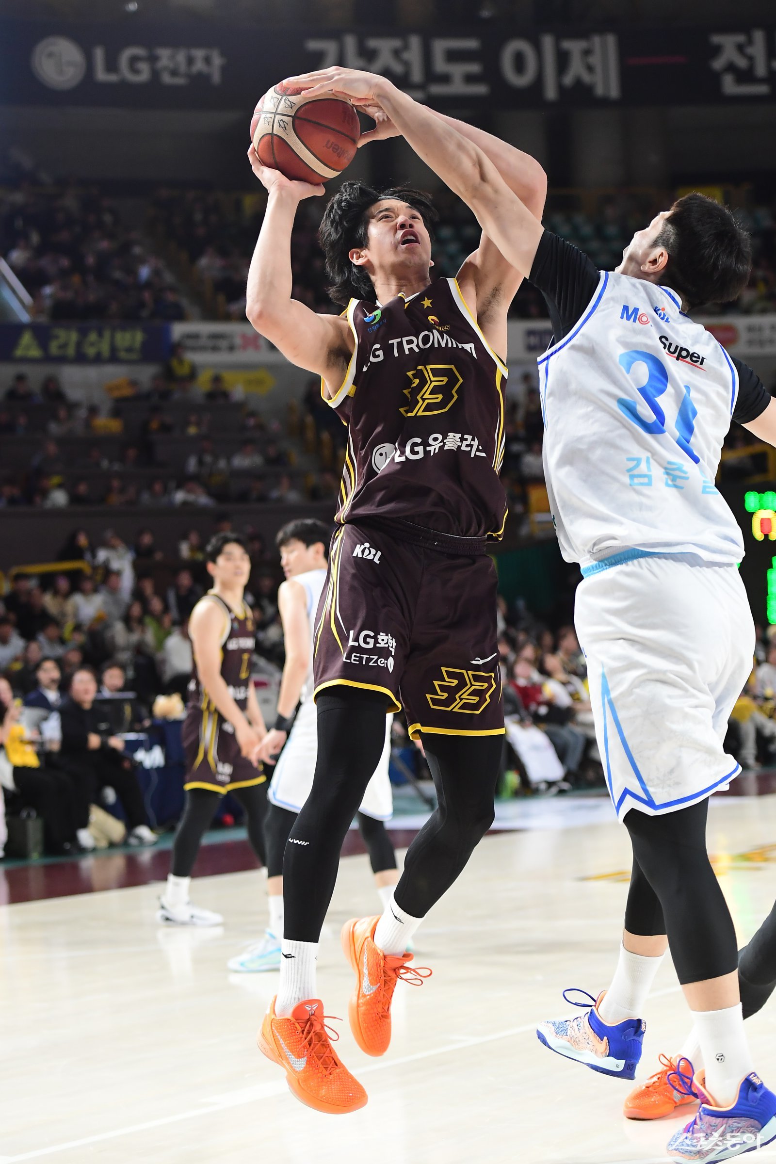 LG 칼 타마요(왼쪽)가 23일 창원체육관에서 열린 한국가스공사전 도중 김준일의 블로킹을 피해 골밑슛을 시도하고 있다. 사진제공 ｜KBL