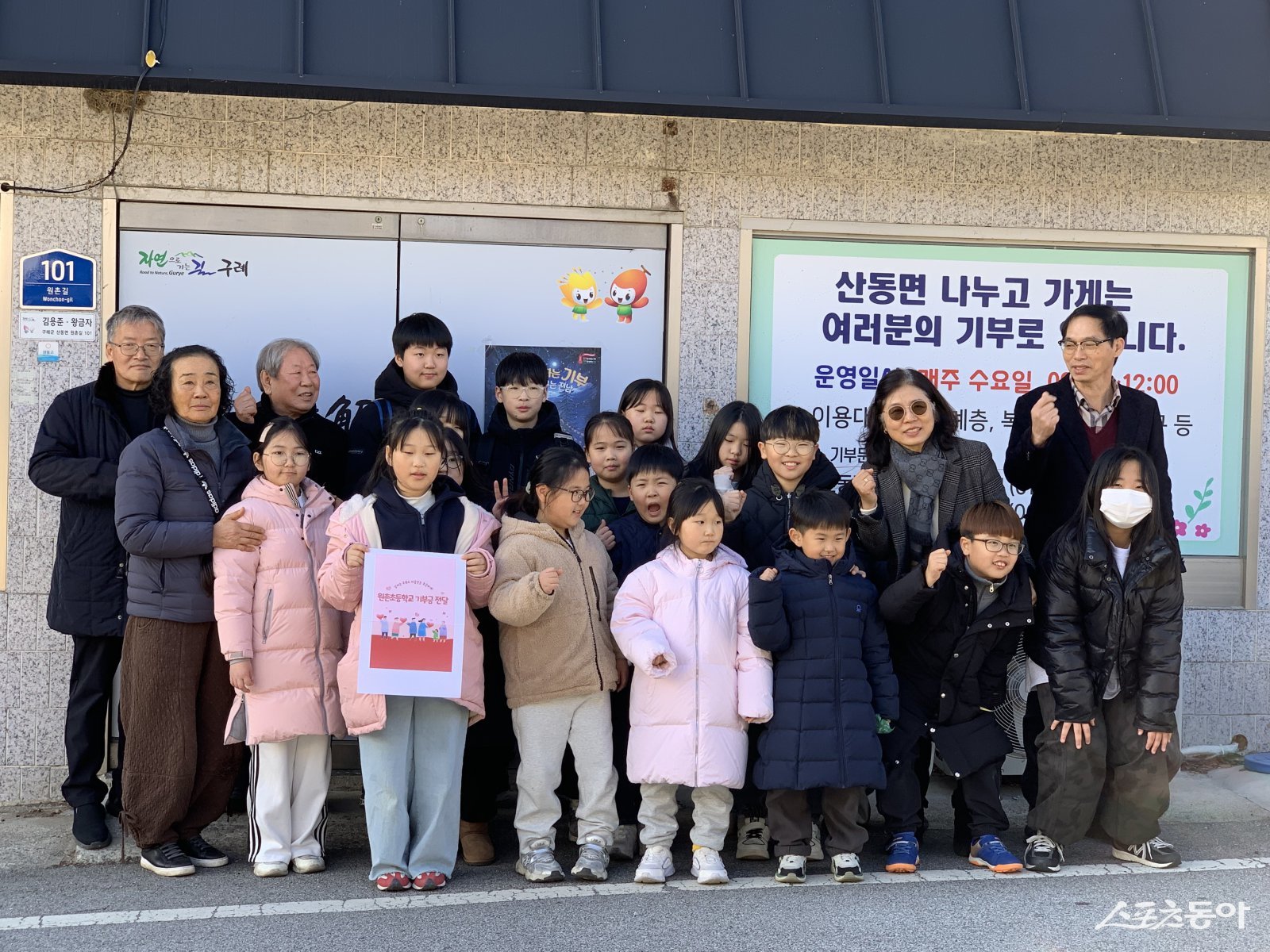 구례군 산동면 원촌초등학교 학생들이 ‘산동 나누고 가게’를 방문해 성금 20만원을 전달하고 기념 촬영을 하고 있다. 사진제공=구례군