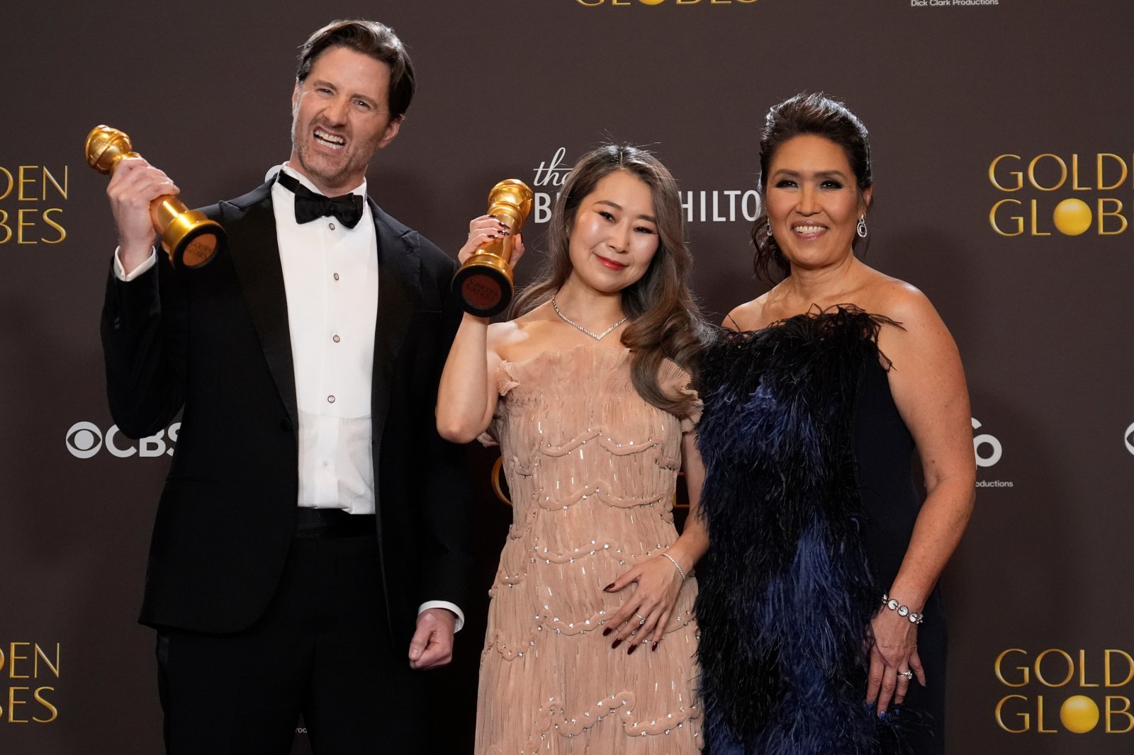 Chris Appelhans, from left, Maggie Kang, and Michelle Wong pose in the press room with the award for best motion picture ? animated for “Kpop Demon Hunters” during the 83rd Golden Globes on Sunday, Jan. 11, 2026, at the Beverly Hilton in Beverly Hills, Calif. (AP Photo/Chris Pizzello)