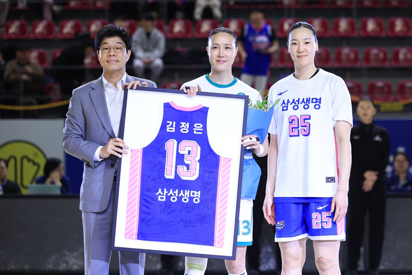 하나은행 김정은(가운데)이 4일 용인체육관서 열린 ‘BNK금융 2025~2026 여자프로농구’ 5라운드 삼성생명전을 앞두고 하상윤 삼성생명 감독(왼쪽)과 배혜윤으로부터 은퇴 투어 선물을 받고 있다. 사진제공｜WKBL