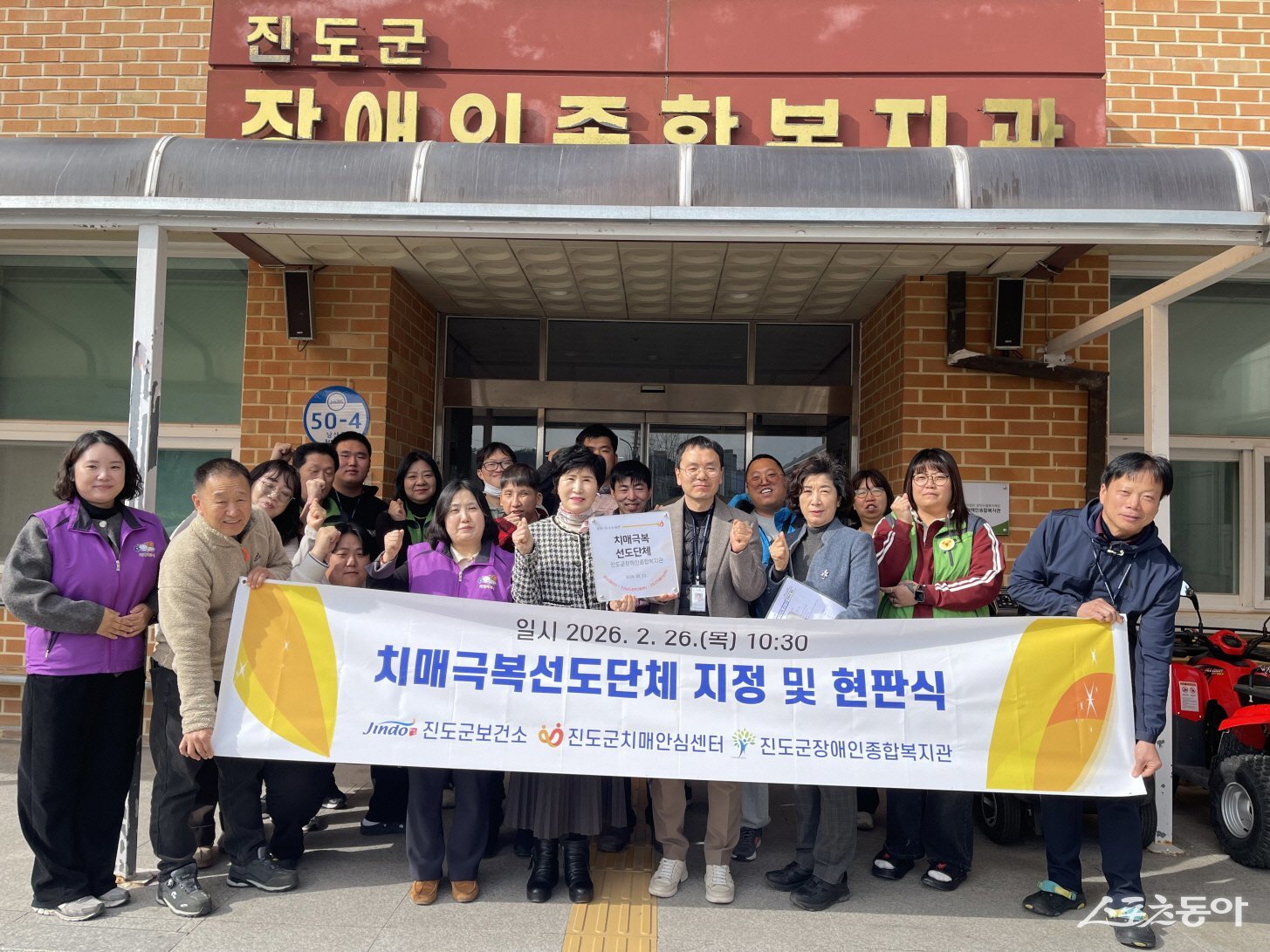 진도군 보건소는 지난 2월 26일, 진도군장애인종합복지관을 치매극복선도단체로 신규 지정하고 복지관에서 현판식을 진행하고 기념촬영을 하고 있다. 사진제공│진도군