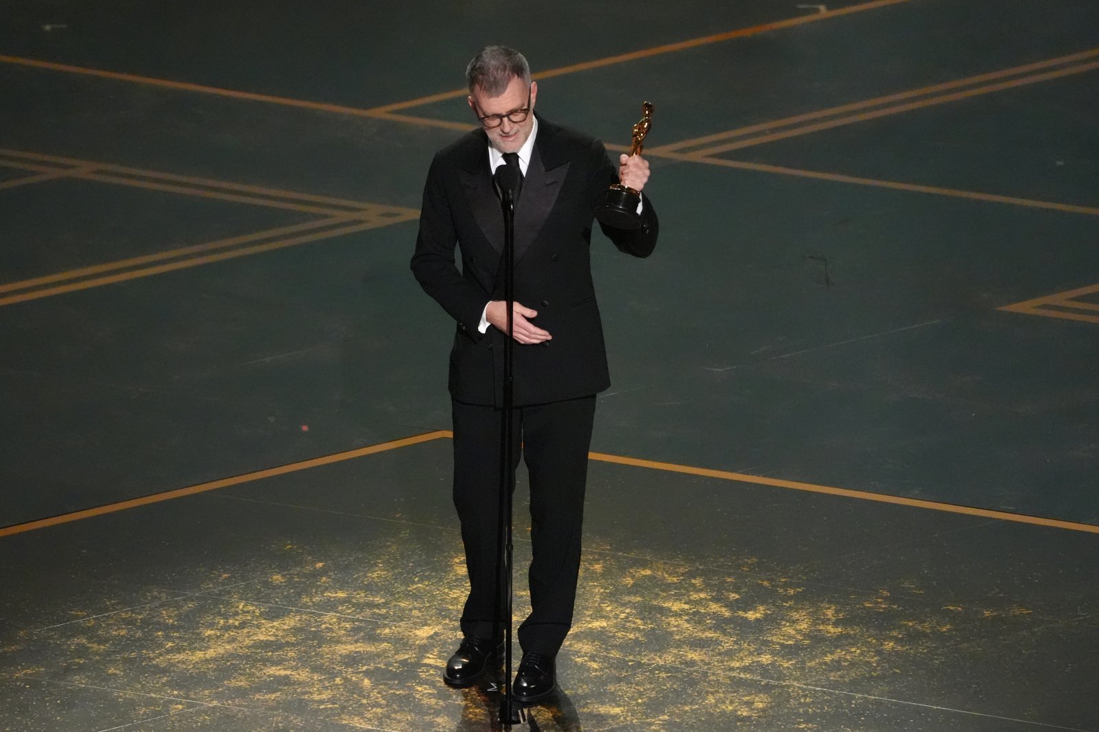 Paul Thomas Anderson accepts the award for writing (adapted screenplay) for “One Battle After Another” during the Oscars on Sunday, March 15, 2026, at the Dolby Theatre in Los Angeles. (AP Photo/Chris Pizzello)