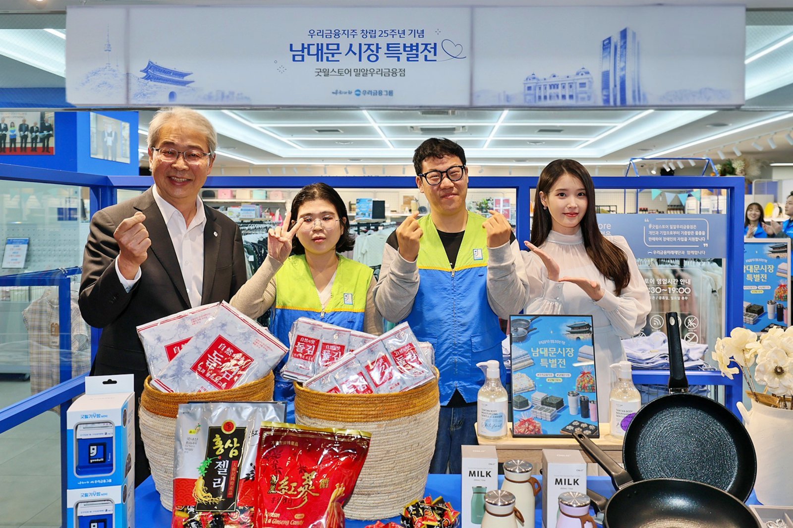 굿윌스토어 ‘남대문시장 특별전’에서 점원들과 기념 촬영을 하는 임종룡 우리금융 회장(맨 왼쪽), 모델 아이유(맨 오른쪽). 사진제공|우리은행