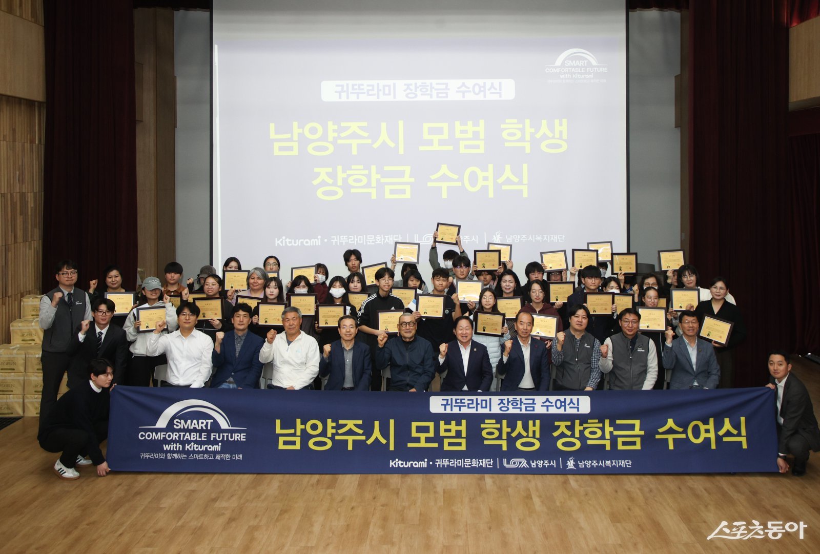 21일 귀뚜라미그룹이 남양주시 모범 학생에게 장학금 5천만 원을 수여하고 있다. 앞줄 오른쪽 5번째가 주광덕 시장. 사진제공ㅣ남양주시 