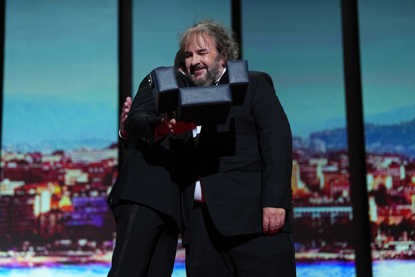 Elijah Wood, left, and director Peter Jackson, recipient of the honorary Palme d‘Or, embrace during the opening ceremony of the 79th international film festival, Cannes, southern France, Tuesday, May 12, 2026. (Photo by Scott A Garfitt/Invision/AP)