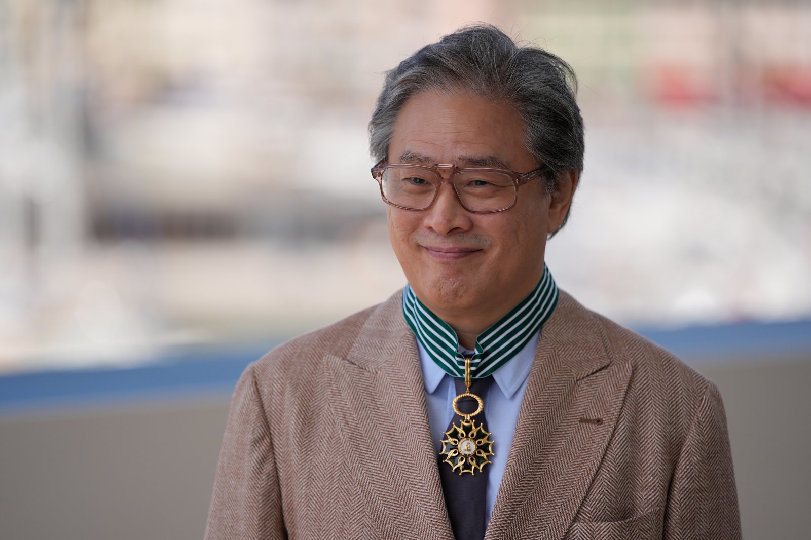 Jury president Park Chan-wook is honoured with The Order of Arts and Letters by the Ministry of Culture during the 79th international film festival, Cannes, southern France, Sunday, May 17, 2026. (AP Photo/John Locher)