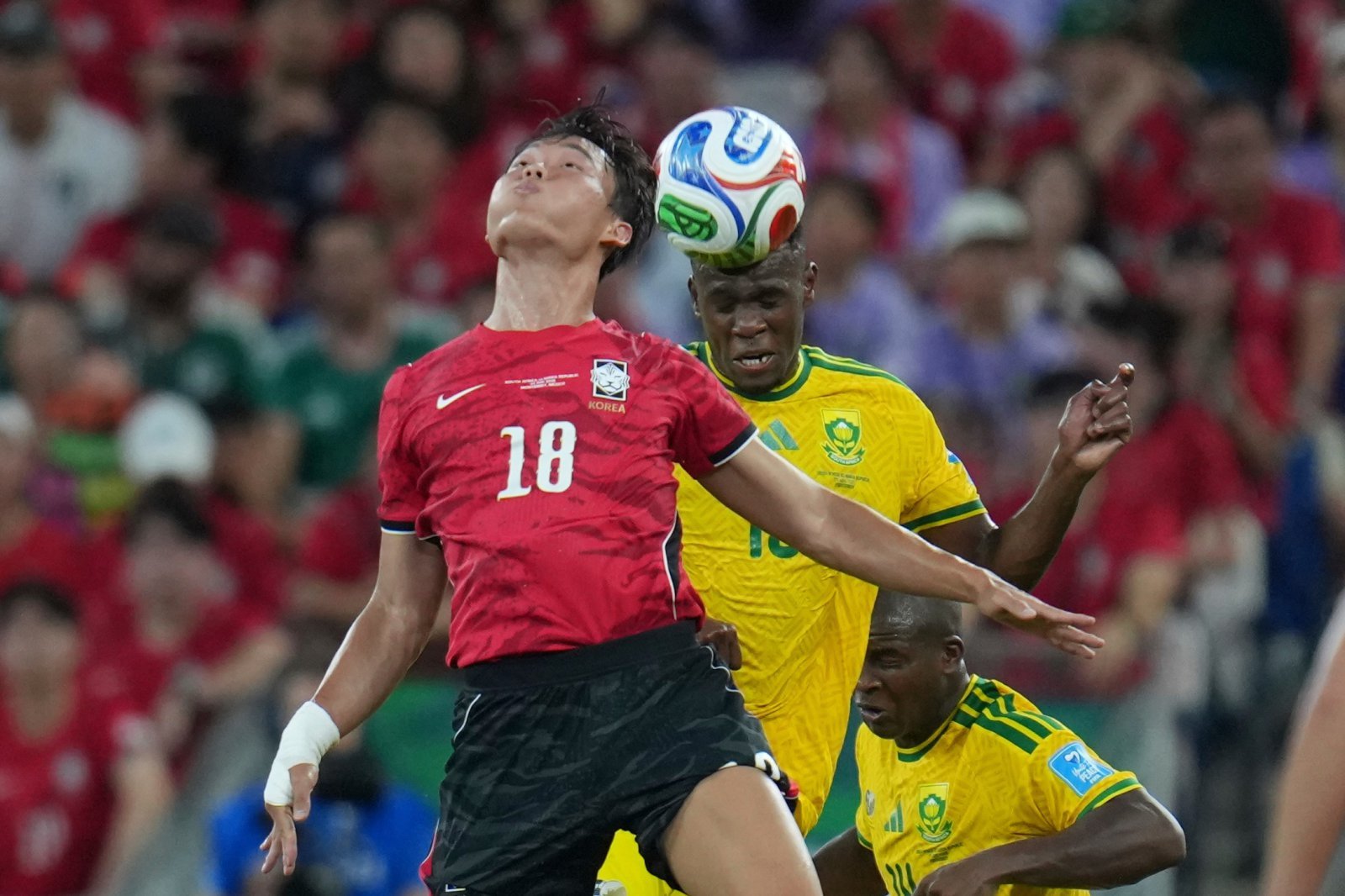 South Korea‘s Oh Hyeon-gyu (18) battles for a header with South Africa’s Sphephelo Sithole (13) during the World Cup Group A soccer match between South Africa and South Korea in Guadalupe, near Monterrey, Mexico, Wednesday, June 24, 2026. (AP Photo/Matias Delacroix)